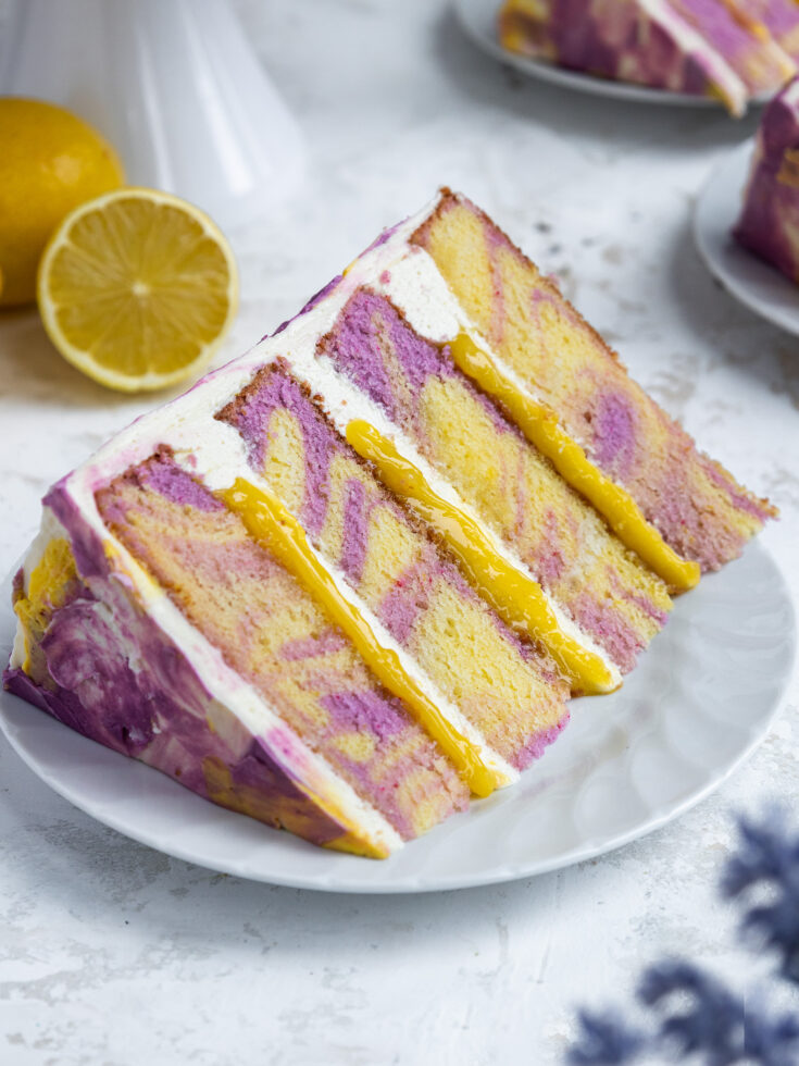 image of a slice of lemon lavender cake that's been placed on a plate