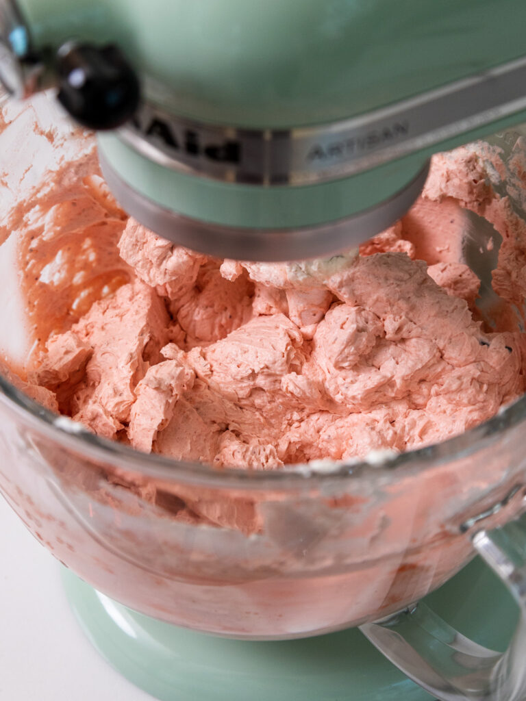 image of strawberry Swiss meringue buttercream that's been mixed in a kitchenaid stand mixer