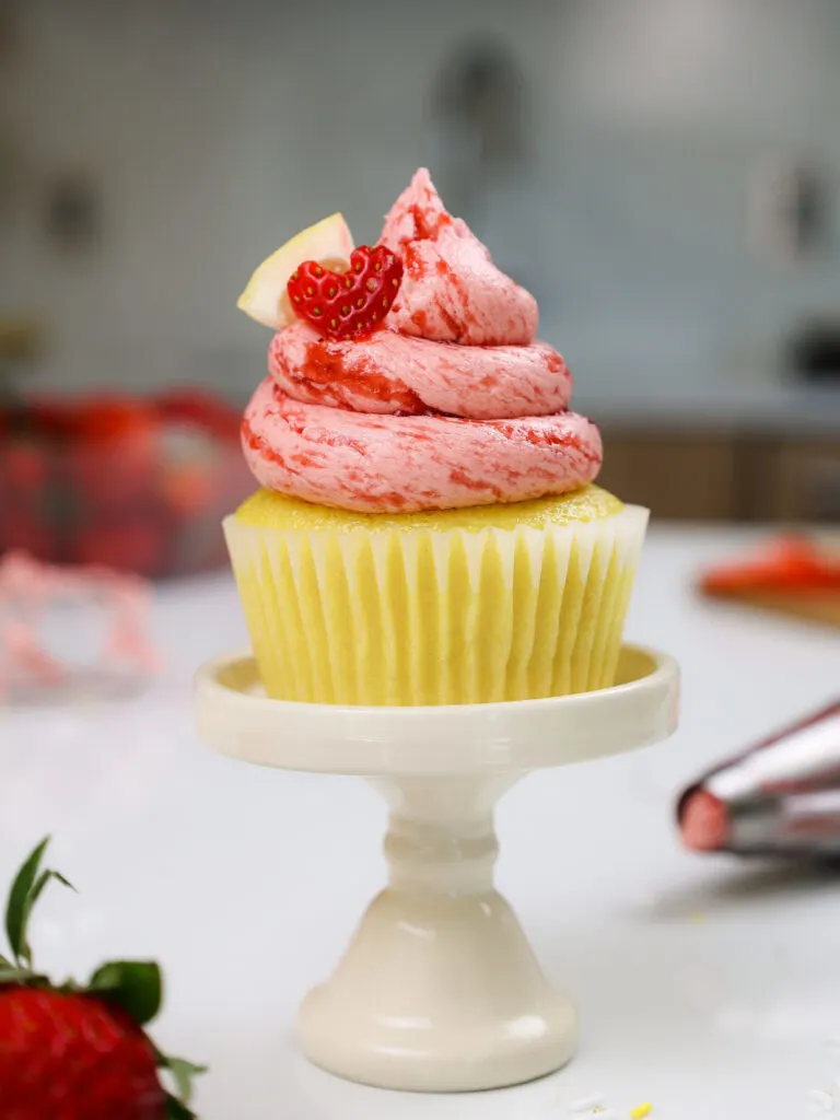 image of strawberry lemonade cupcakes decorated with a little lemon slice and cute heart shaped strawberry slice