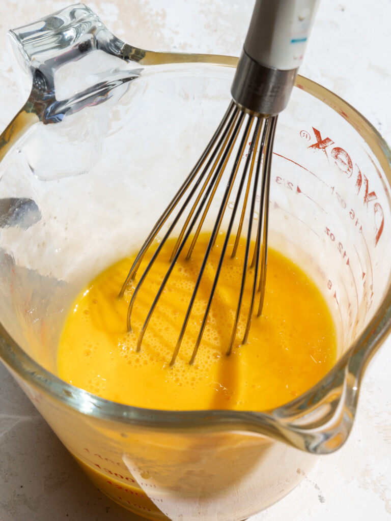 image of eggs being whisked together before being added into cheesecake batter