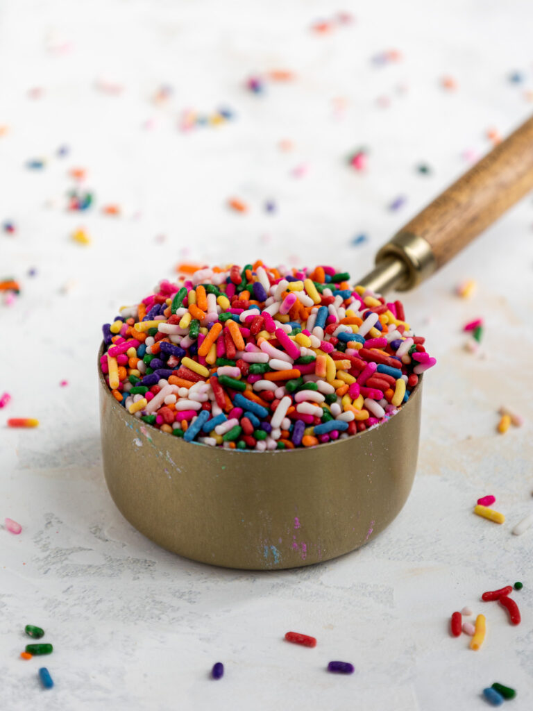 image of rainbow jimmy sprinkles in a measuring cup