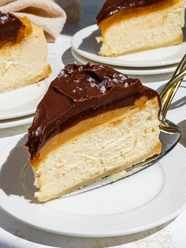 image of a slice of millionaire cheesecake being placed on a small plate