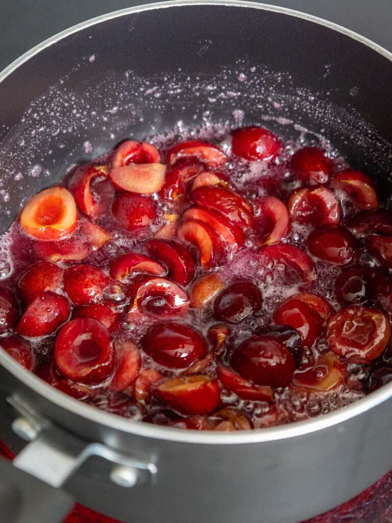 image of cherries being cooked down in a sauce pan to make a cherry dessert topping