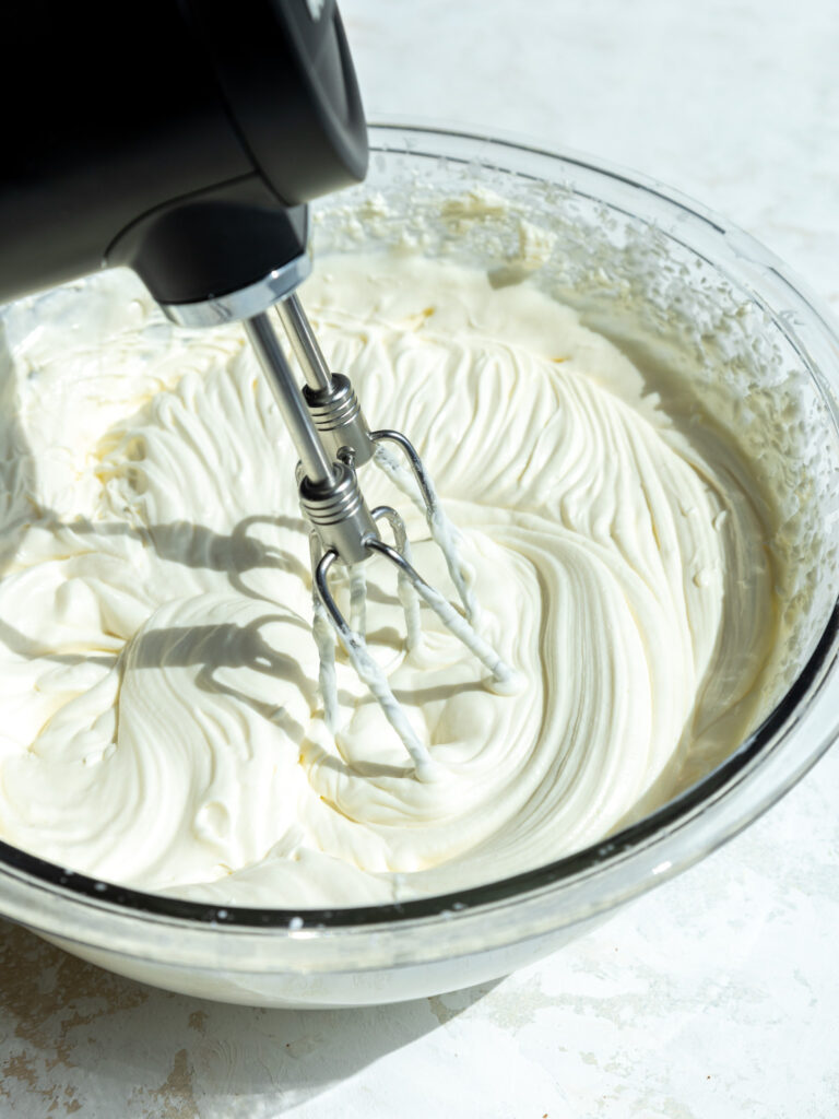 image of stabilized whipped cream being mixed with a hand mixer