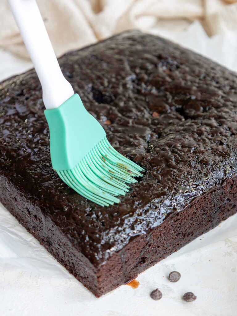 image of a chocolate snack cake being soaked with chocolate simple syrup