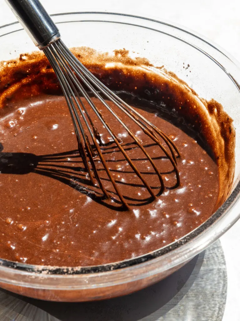 image of chocolate cake batter being whisked together in bowl