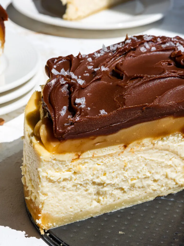 image of a millionaire cheesecake that's been cut into to show it's layers of caramel and chocolate ganache