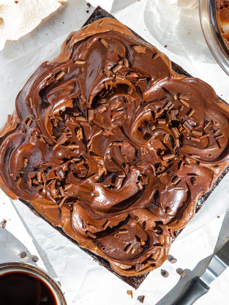 image of a chocolate snack cake that's been frosted with chocolate buttercream and swirled with chocolate ganache