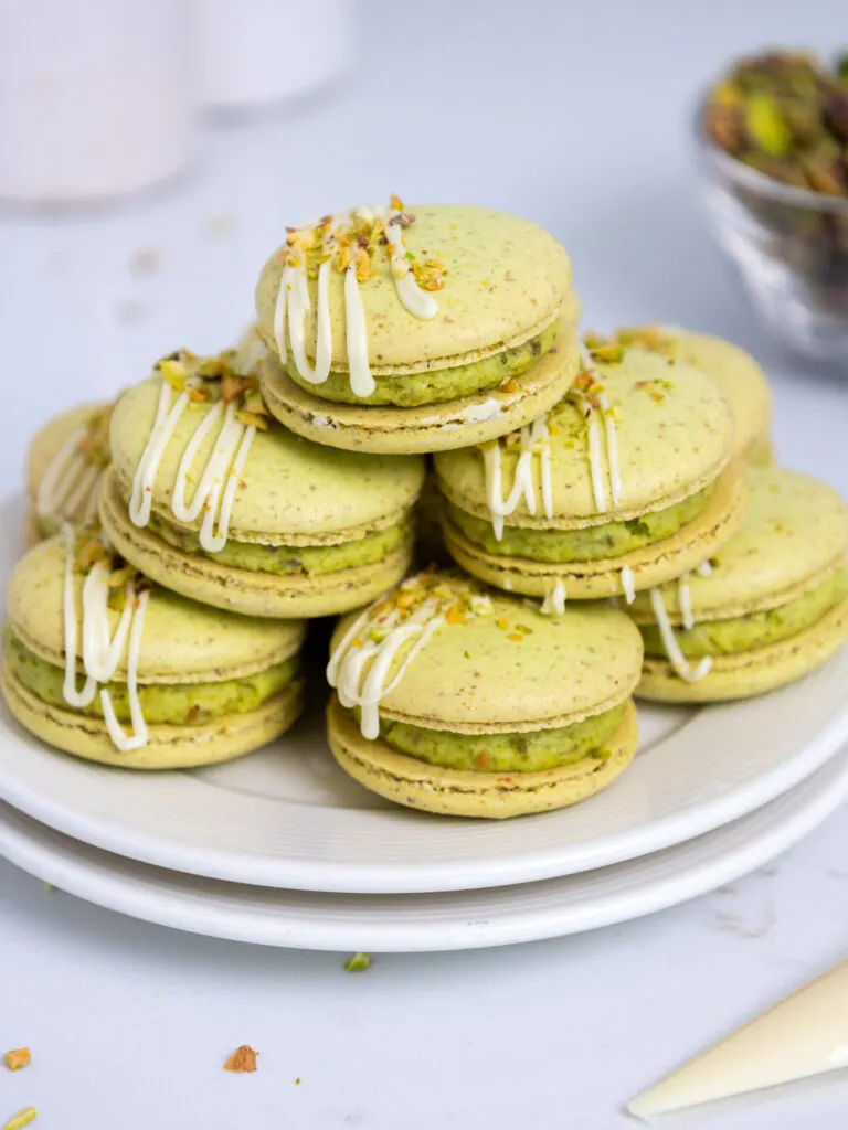 image of pistachio macarons stacked on a small plate