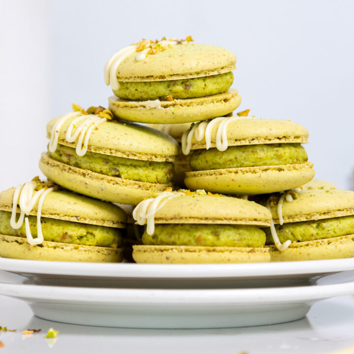 image of pistachio macarons stacked on a small plate