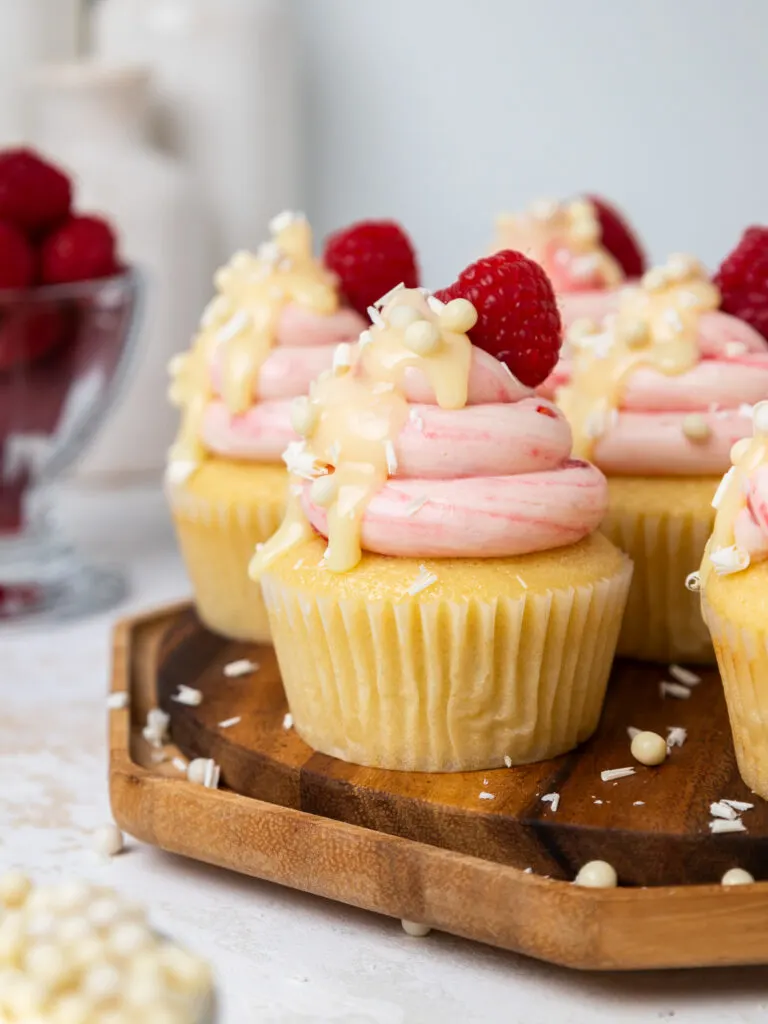 image of raspberry white chocolate cupcakes drizzled with white chocolate ganache