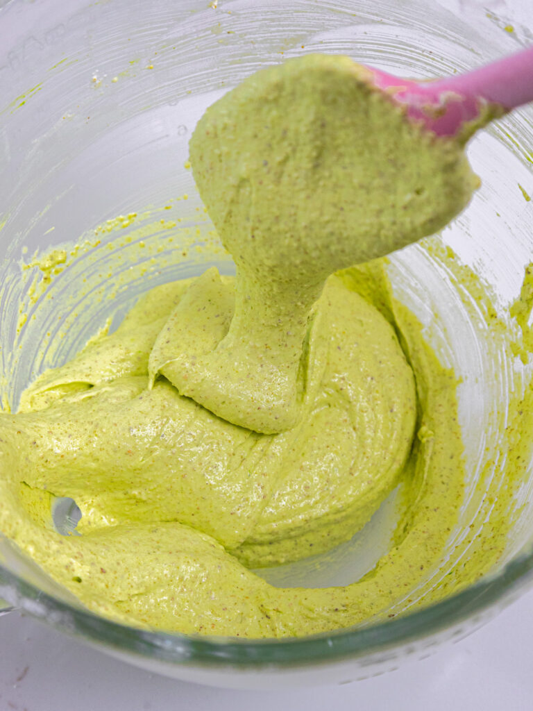 folding pistachio macaron batter until thick ribbons fall of a rubber spatula when it is lifted