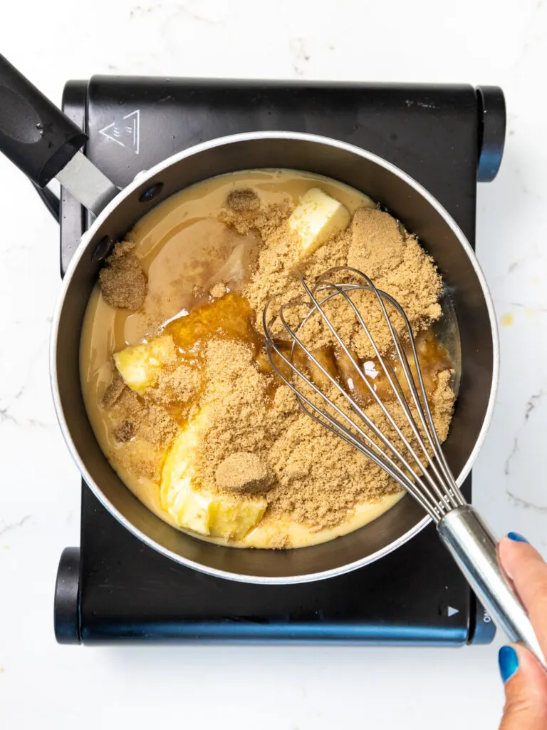 image of ingredients being whisked together over a stove top to make a thick caramel topping
