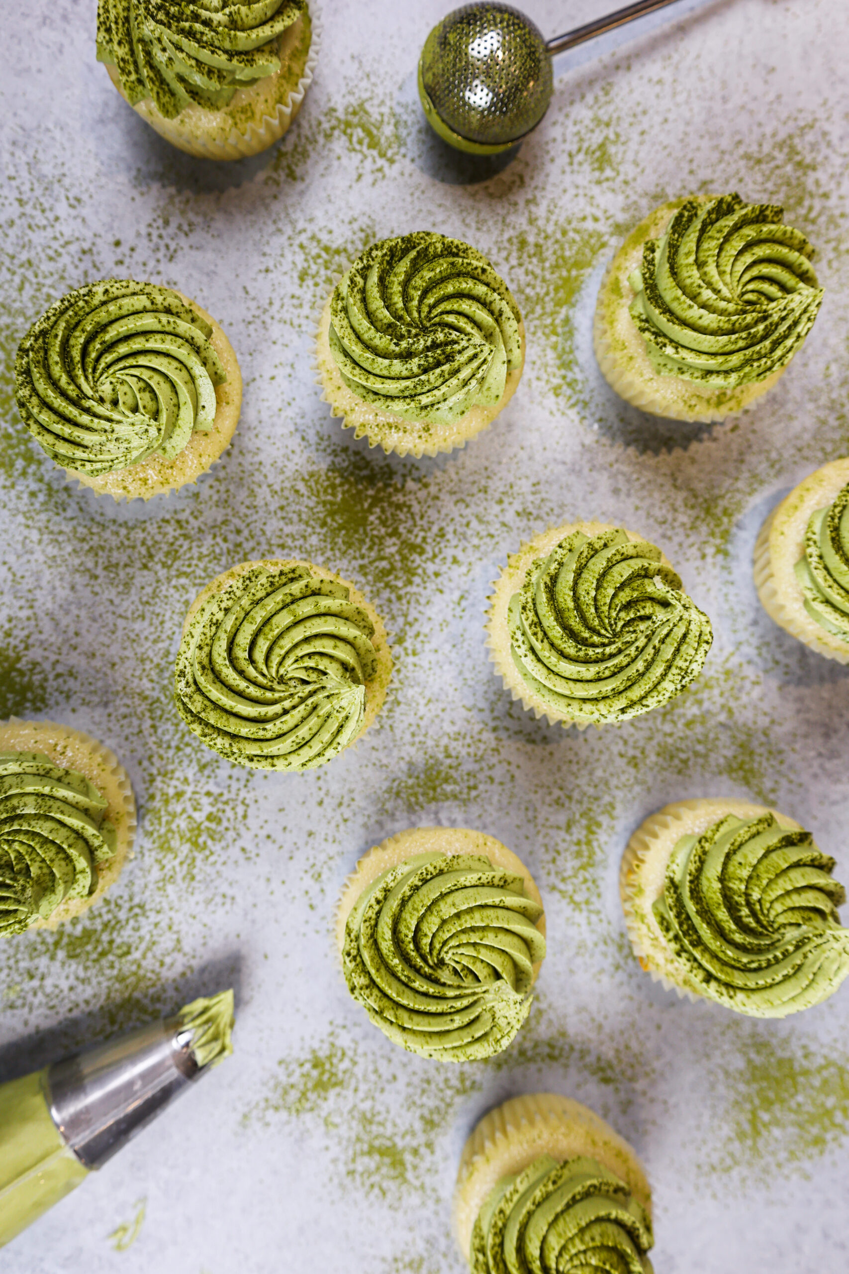 image of matcha cupcakes from overhead that have been frosted with matcha buttercream and dusted with matcha powder