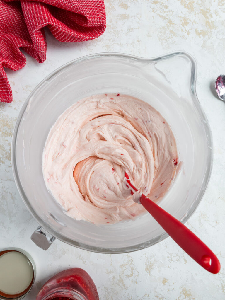 image of raspberry buttercream frosting being mixed together