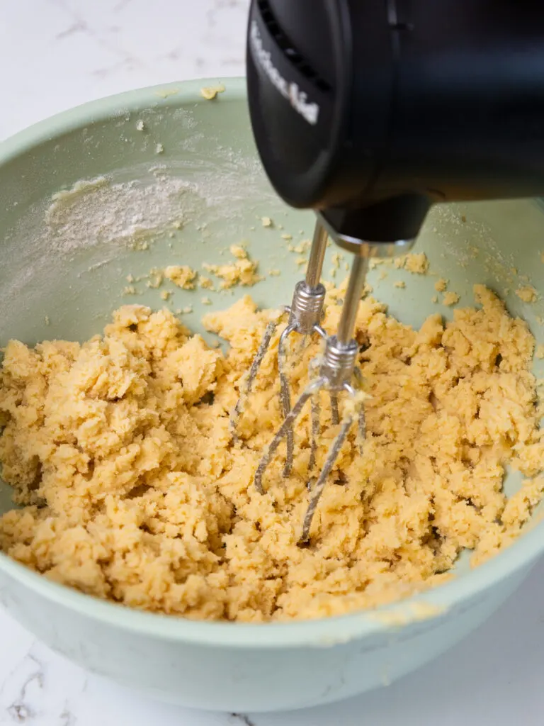 image of shortbread crust being mixed together with a handmixer