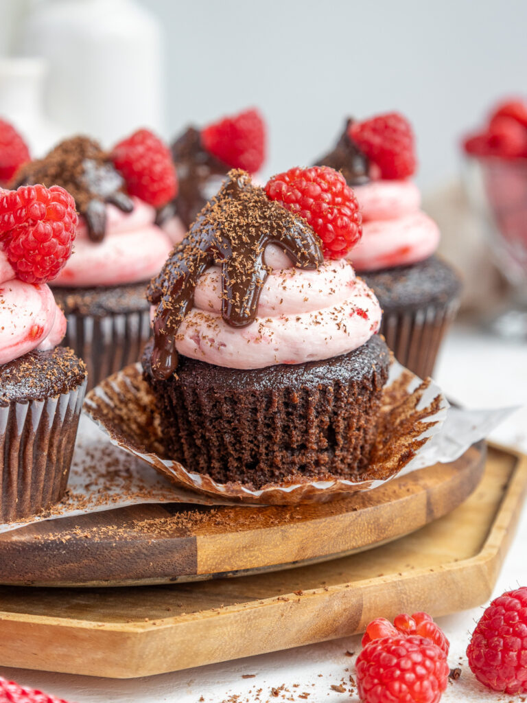 image of chocolate raspberry cupcakes that have been cut into to show the raspberry jam filling