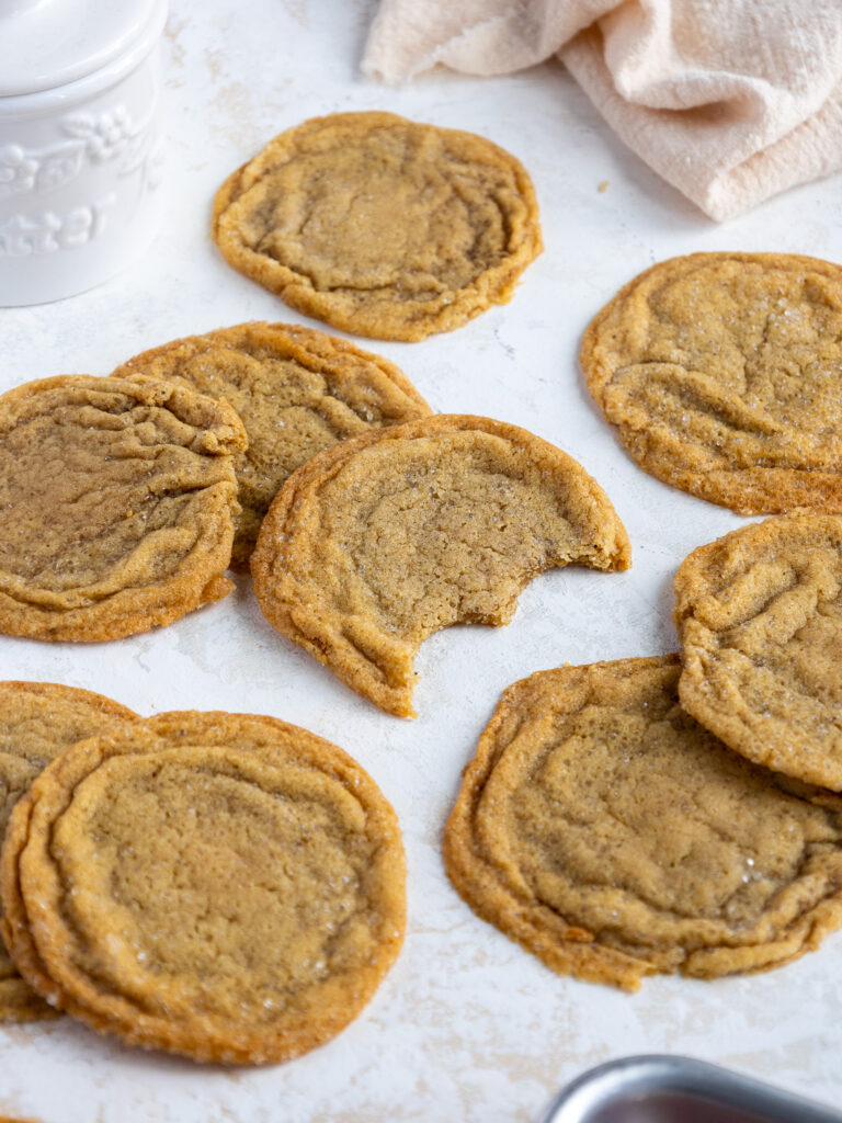 image of brown butter sugar cookies that have been bitten into to show how chewy and soft their centers are