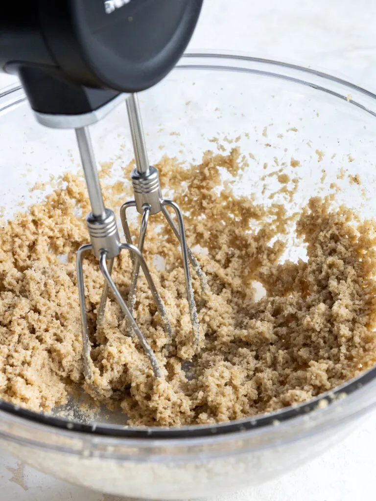 image of brown butter and sugar being creamed together with a hand mixer