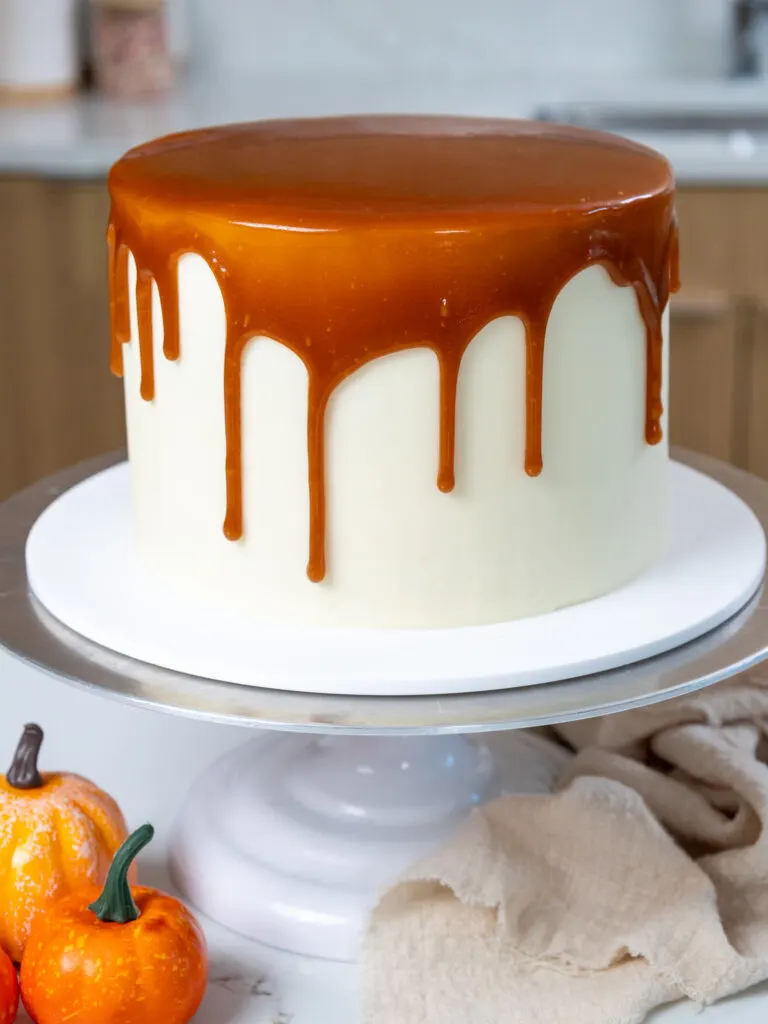 image of a pumpkin caramel cake that's been decorated with a caramel drip