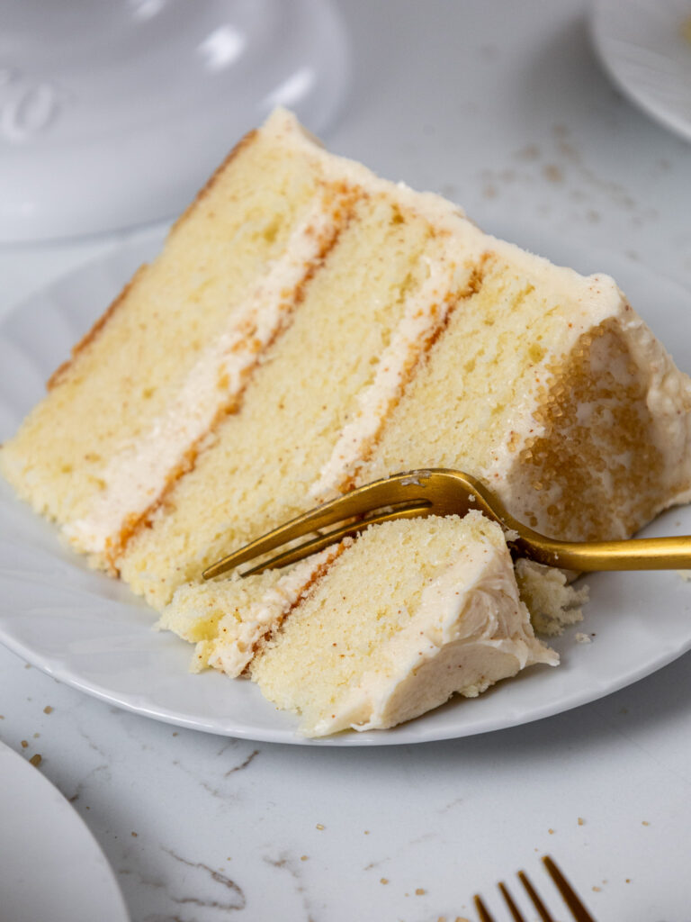 image of a slice of brown butter cake that's been cut into to show how tender its cake layers are