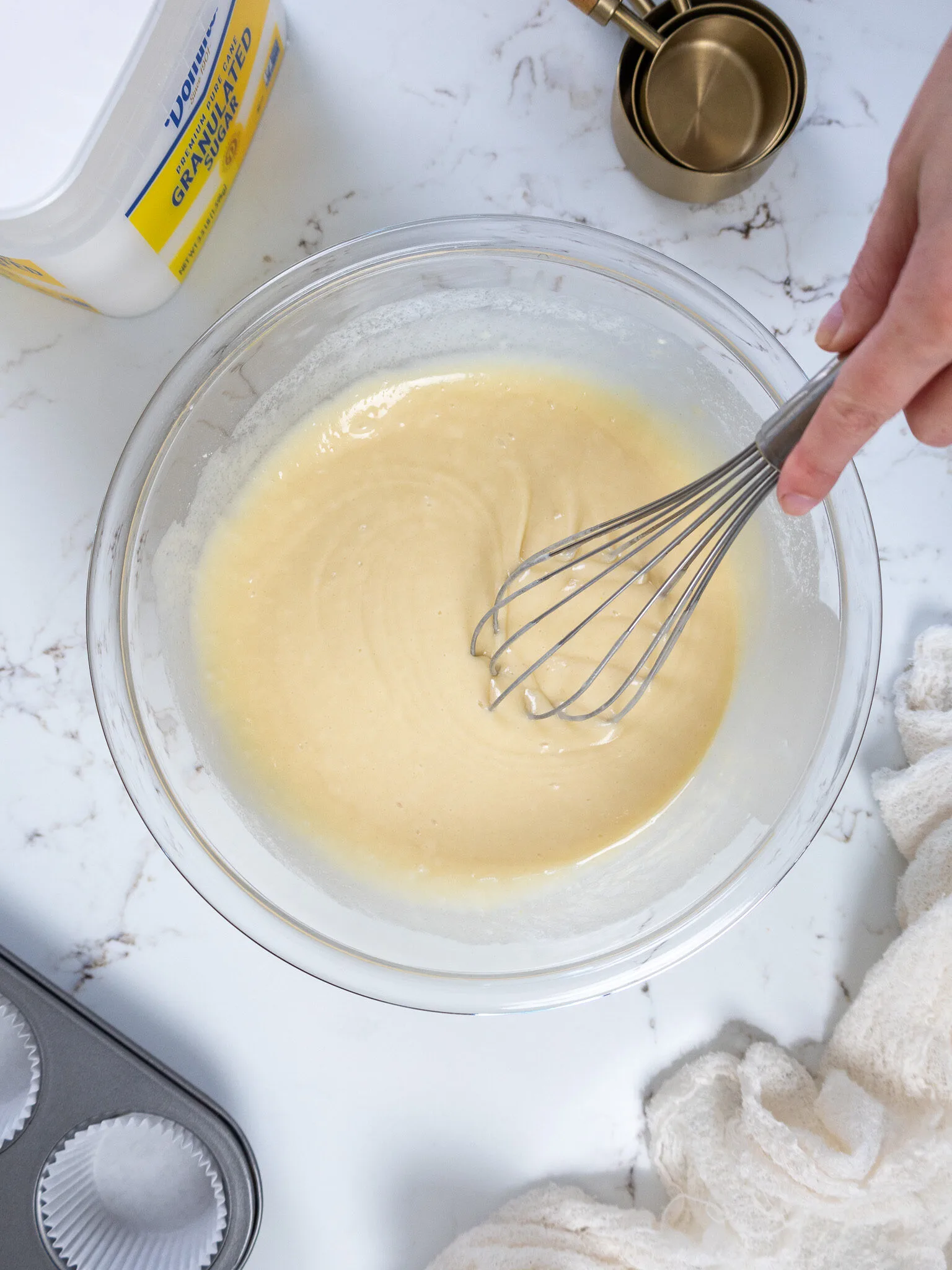 image of vanilla cake batter being whisked together in a glass bowl