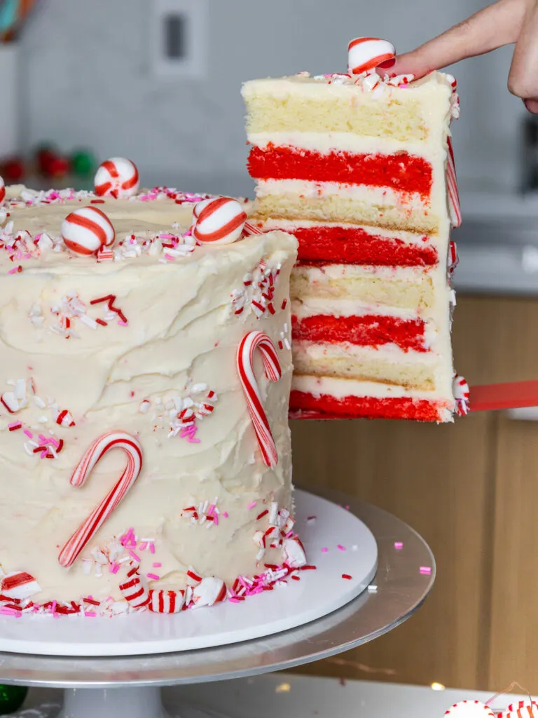 image of a slice of cake being pulled from a candy cane cake