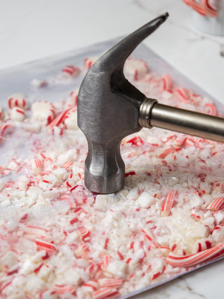 image of peppermint candies being crushed in a plastic bag with a hammer