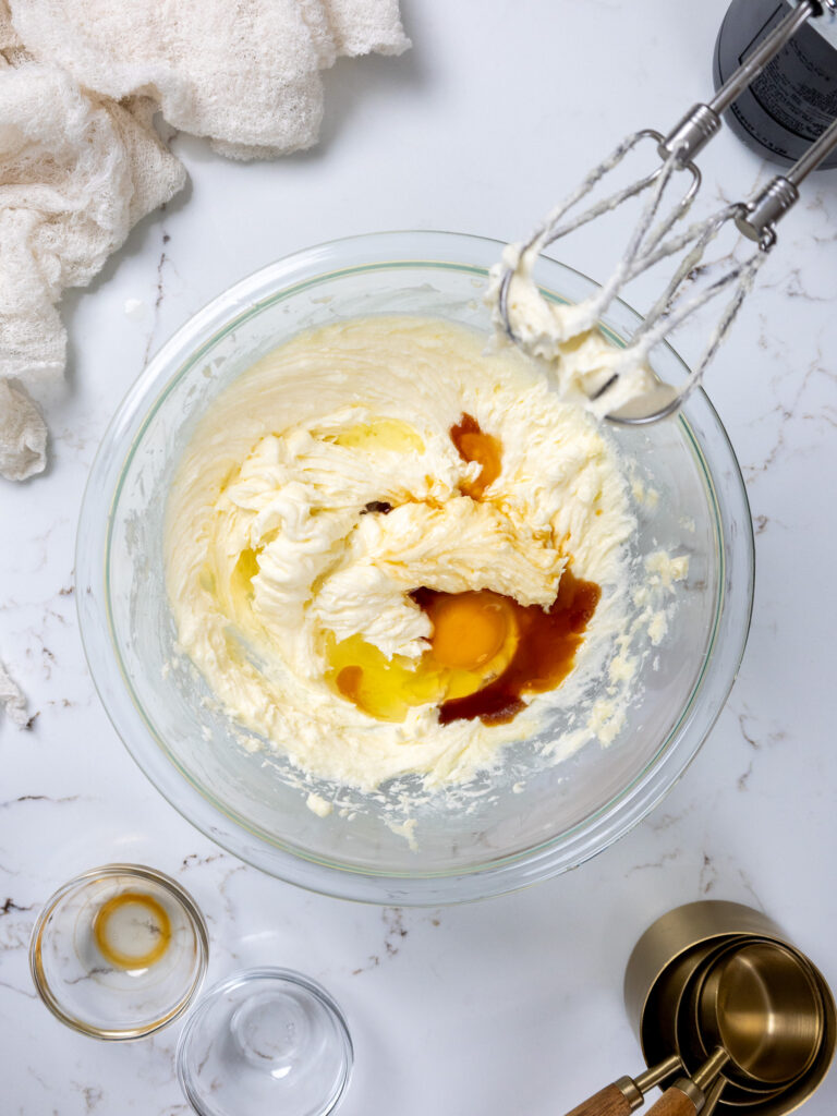 image of wet ingredients being mixed into cream cheese cookie dough