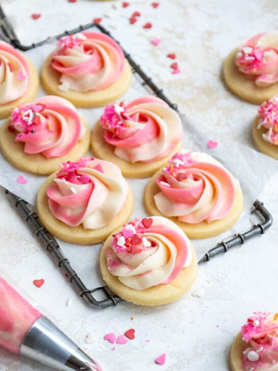 image of buttercream cookies that have been frosted with pink and white buttercream