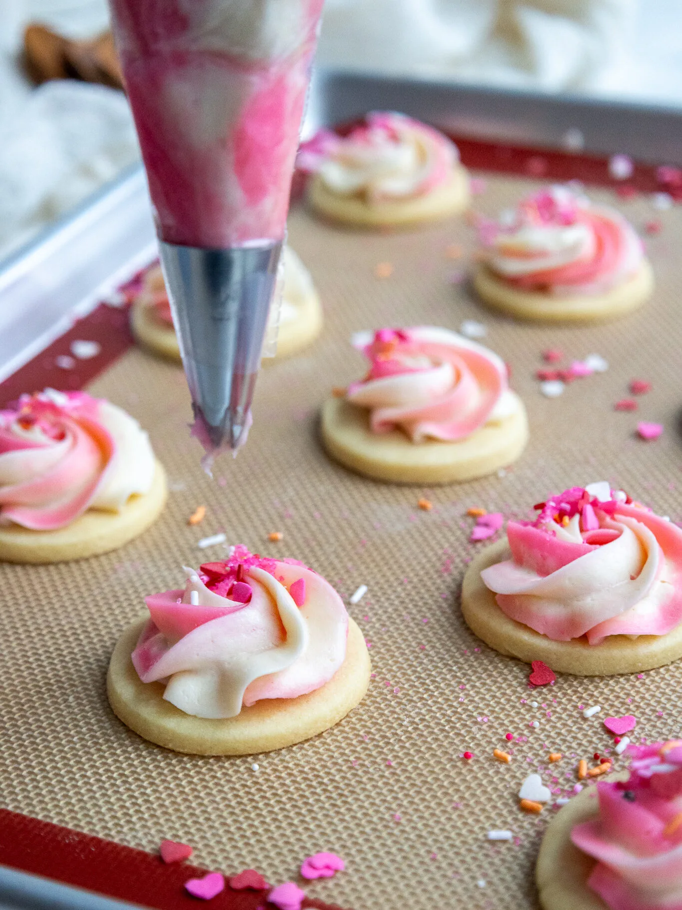 image of cream cheese sugar cookies being frosted with American buttercream
