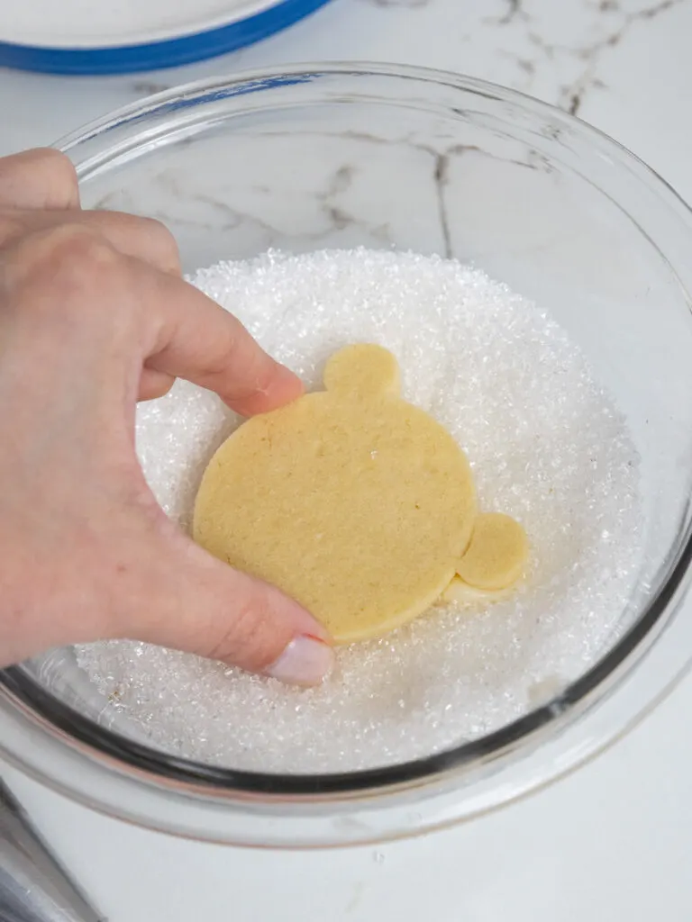 image of a polar bear cookie being dunked in sanding sugar