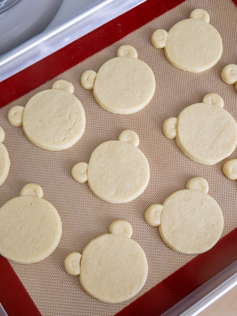 image of bear shaped cookies that have been baked on a baking sheet and are cooling