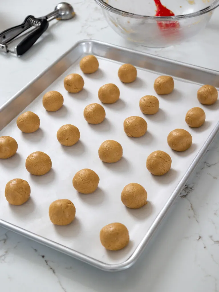 image of peanut butter balls being rolled out to make buckeyes