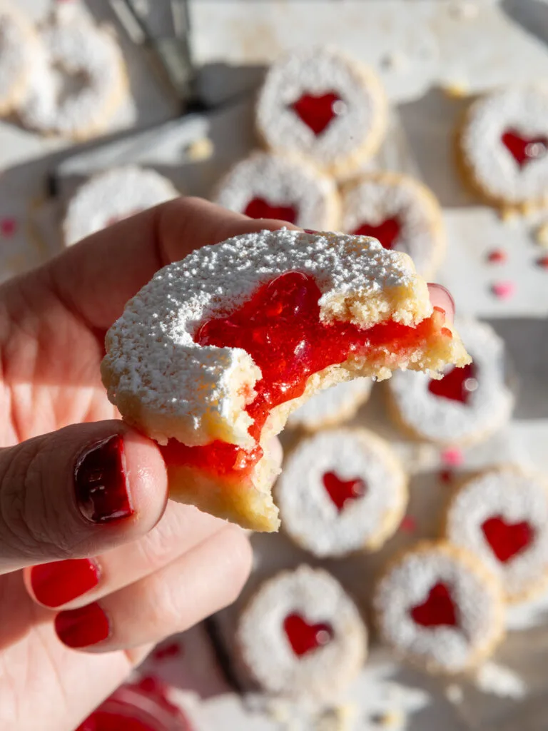 image of a bitten into raspberry Linzer cookie