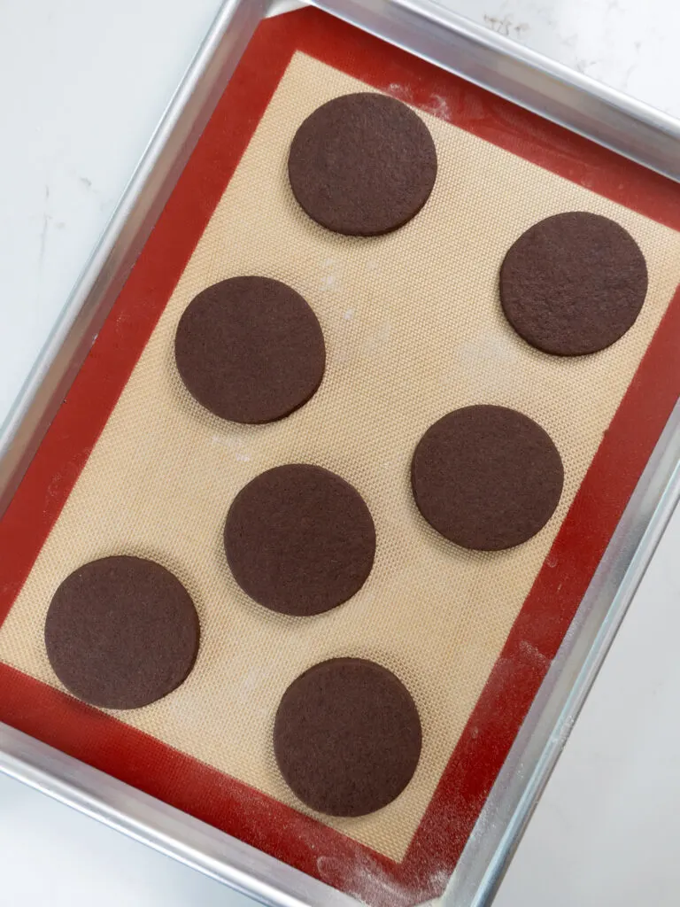 image of chocolate cream cheese cookies that have been cut out and placed on a silicone lined baking tray