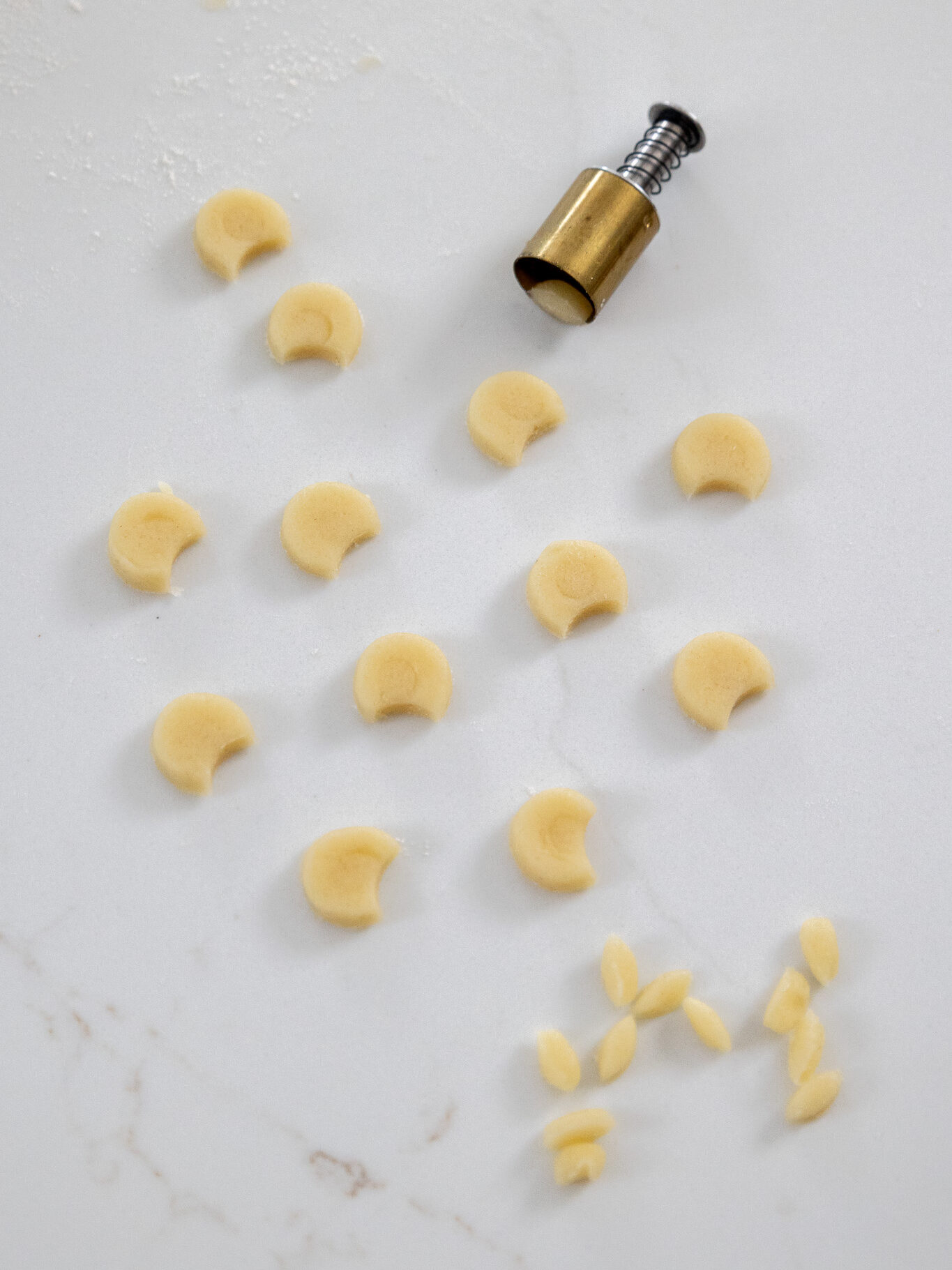 image of cookie dough being cut out to make ears for polar bear cookies