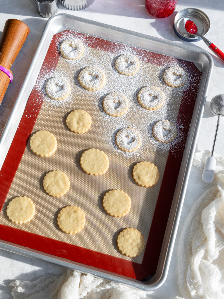 image of baked linzer cookies that have been dusted with powdered sugar