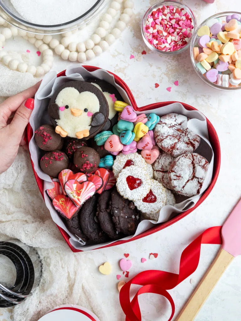 image of a cute valentine's day dessert box that's been filled with an assortment of cookies a truffles