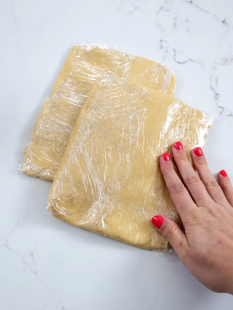 image of shortbread cookie dough that's been wrapped in plastic wrap and is ready to be chilled
