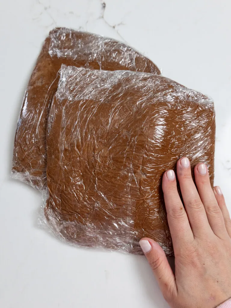 image of chocolate cookie dough that's been wrapped in plastic wrap to be chilled