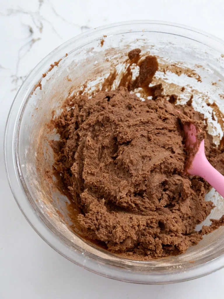 image of chocolate cream cheese cookie dough that's been mixed in a glass bowl