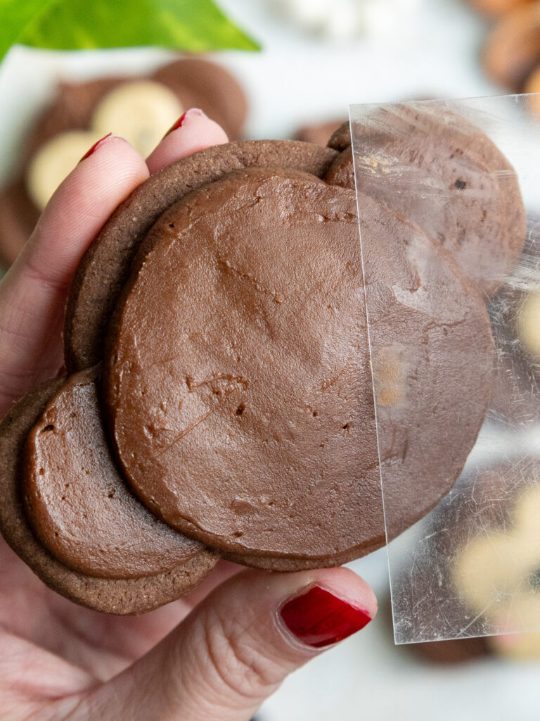 image of chocolate buttercream being smoothed onto a monkey cookie