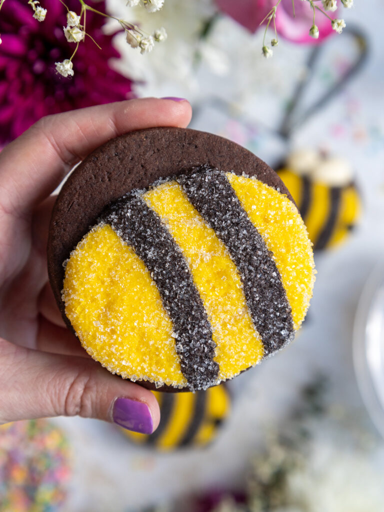 image of a bumble bee cookie that's been dunked in sanding sugar to give it a furry look