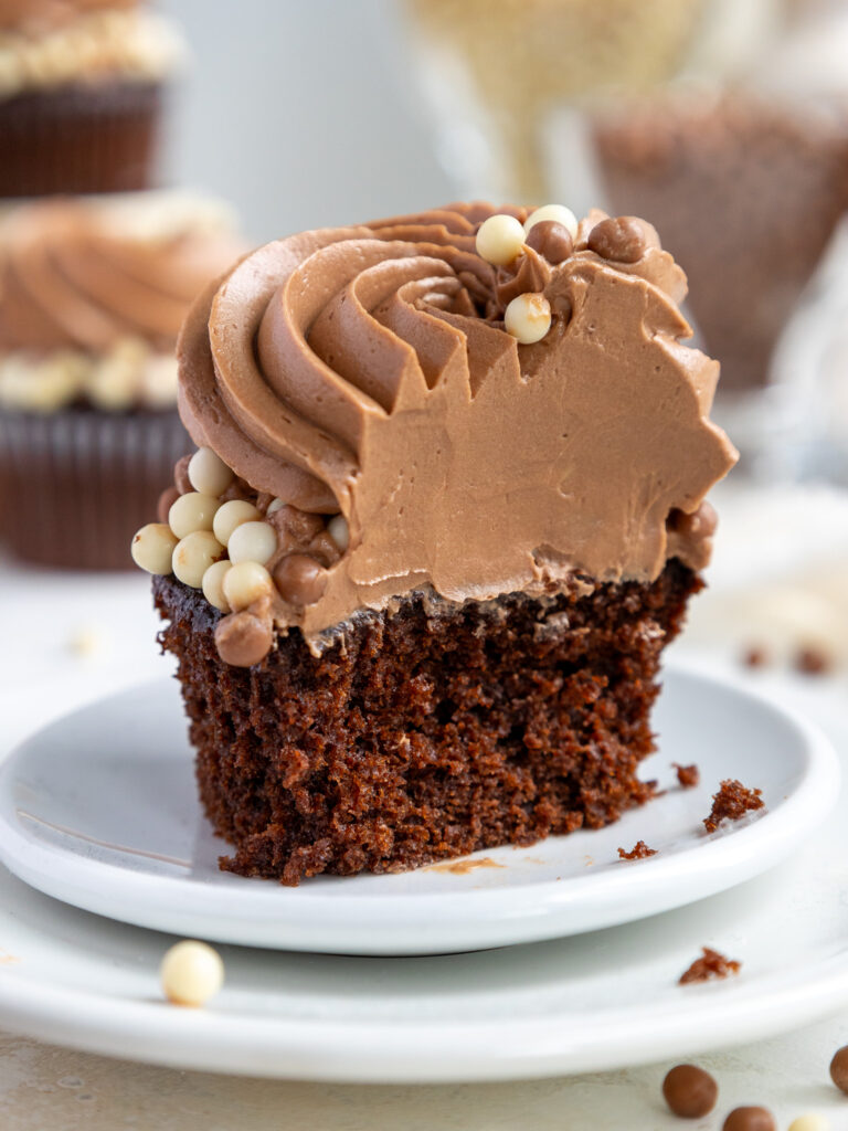image of a chocolate cupcake that's been cut into to show how light and fluffy the chocolate buttercream is
