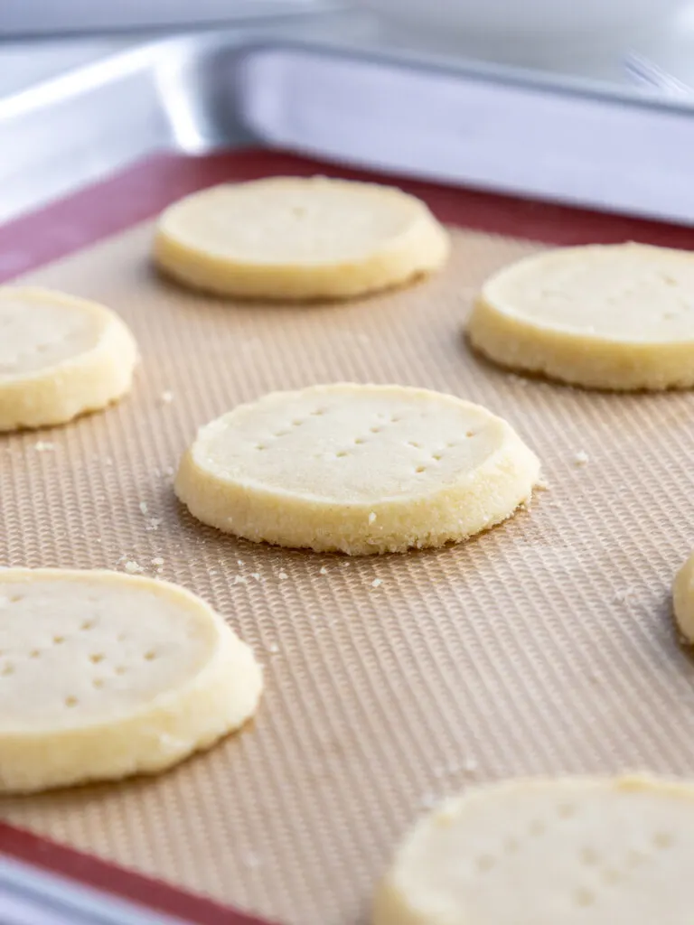 image of baked shortbread cookies that are cooling on the pan before being transferred to a wire cooling rack