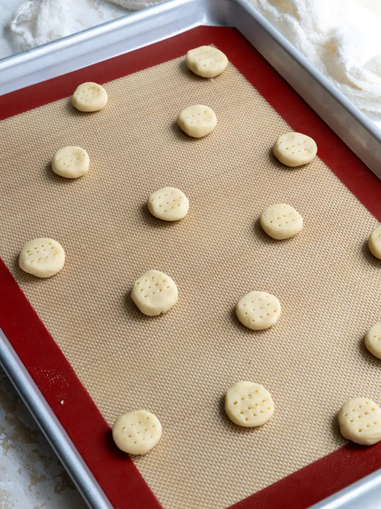 image of mini shortbread cookies on baking mat ready to be baked