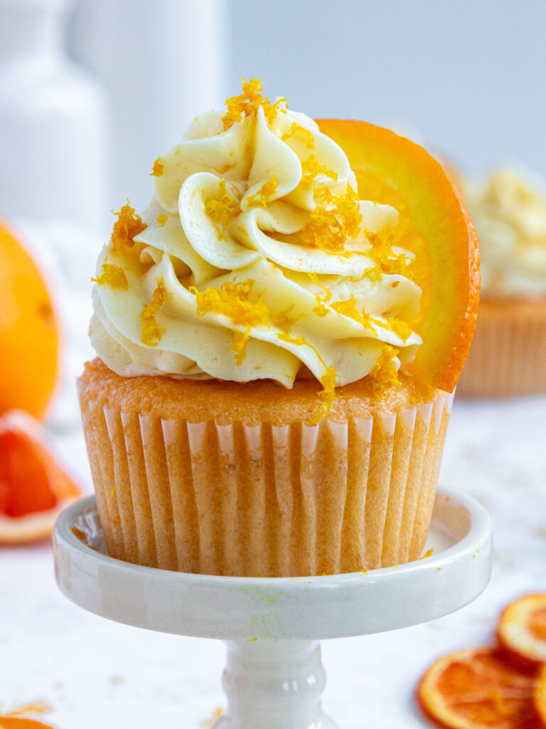 image of an orange cupcake that's been unwrapped to show how moist it is
