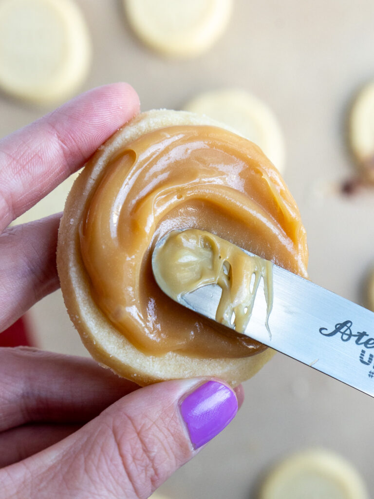 image of caramel being spread on a shortbread cookie