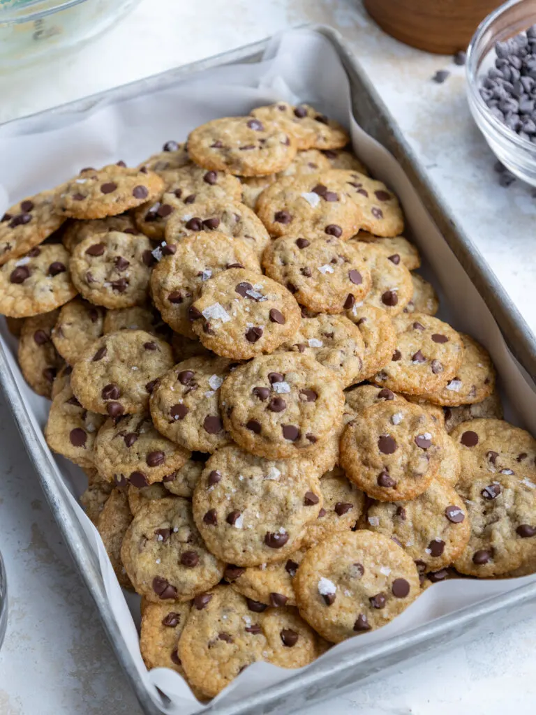 image of a pile of mini chocolate chip cookies in a metal container